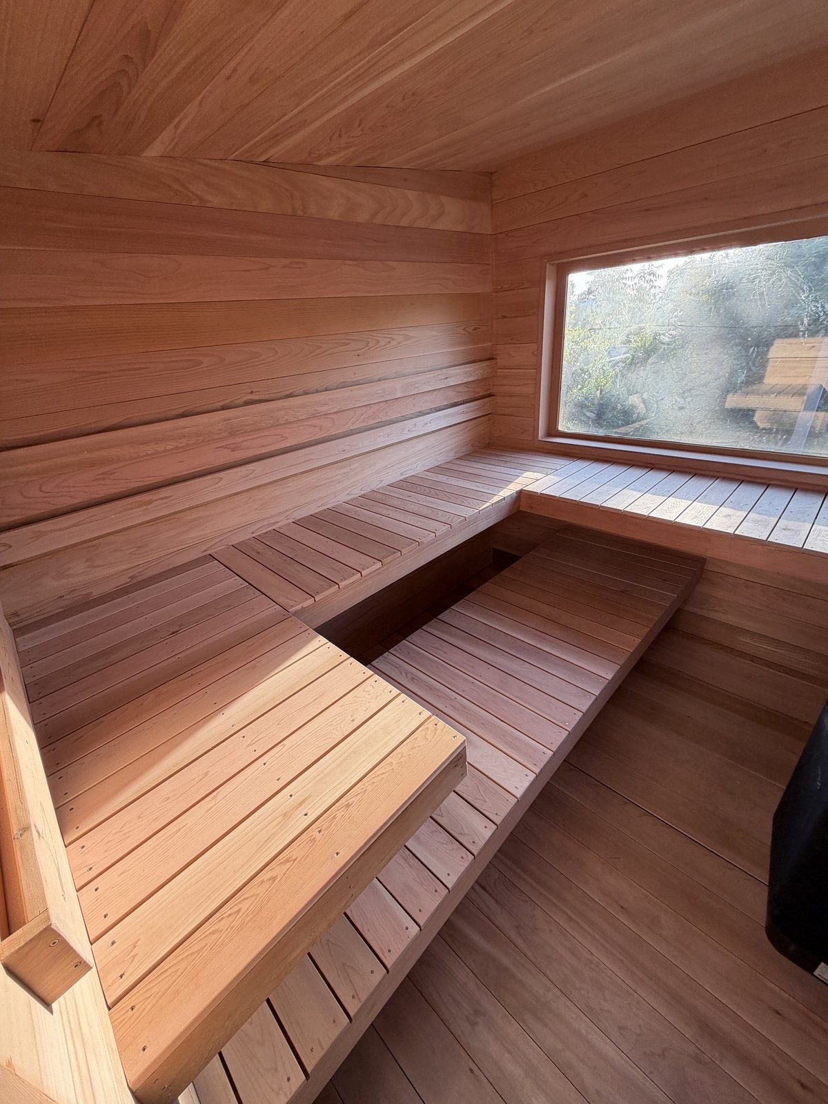 Eight-person cedar sauna built into a hillside
